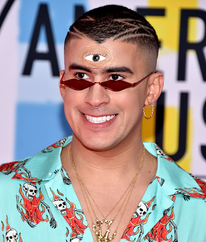 Bad Bunny with red sunglasses and third eye makeup, showcasing his immaculate transformation after Grammy win.