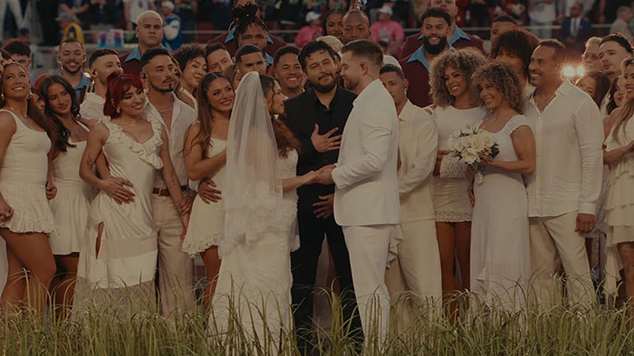 A staged wedding ceremony with Bad Bunny and a crowd dressed in white during the Super Bowl halftime show.