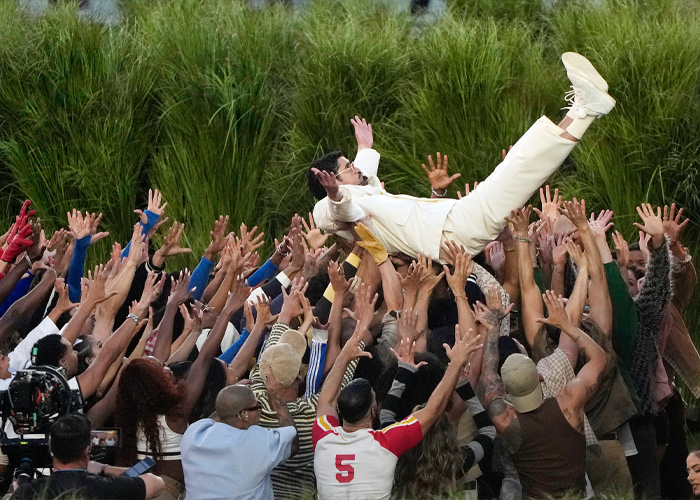 Crowd lifting performer during Super Bowl 2026 halftime show amid public complaints and negative reactions.