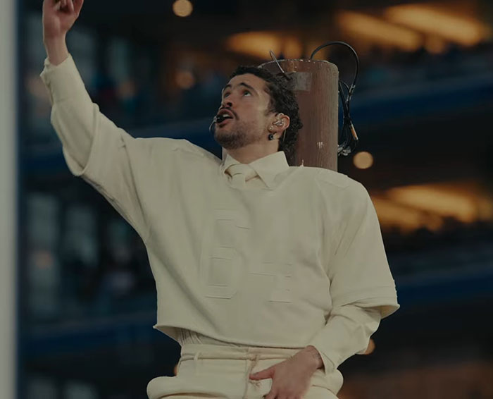 Bad Bunny performing at Super Bowl halftime show, fans debating translations of explicit lyrics during the event.