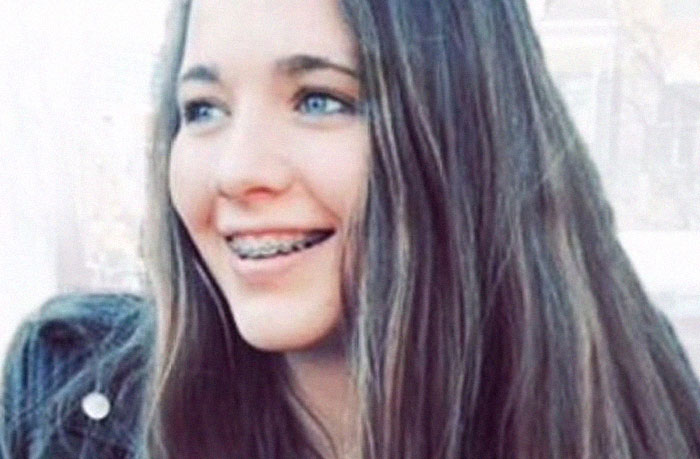 Young woman with braces and long hair smiling, representing an infamous unsolved mystery from around the world.