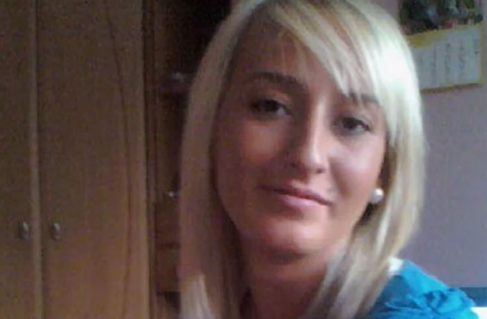 Blonde woman with pearl earrings, smiling softly indoors, related to infamous unsolved mysteries concept.