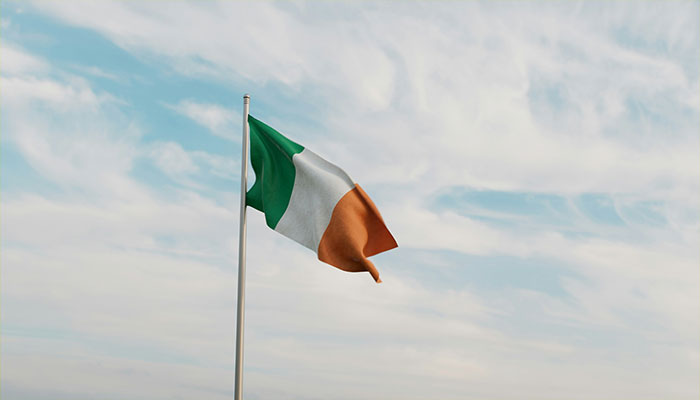 Irish flag waving against a cloudy sky, representing one of the infamous unsolved mysteries from around the world.