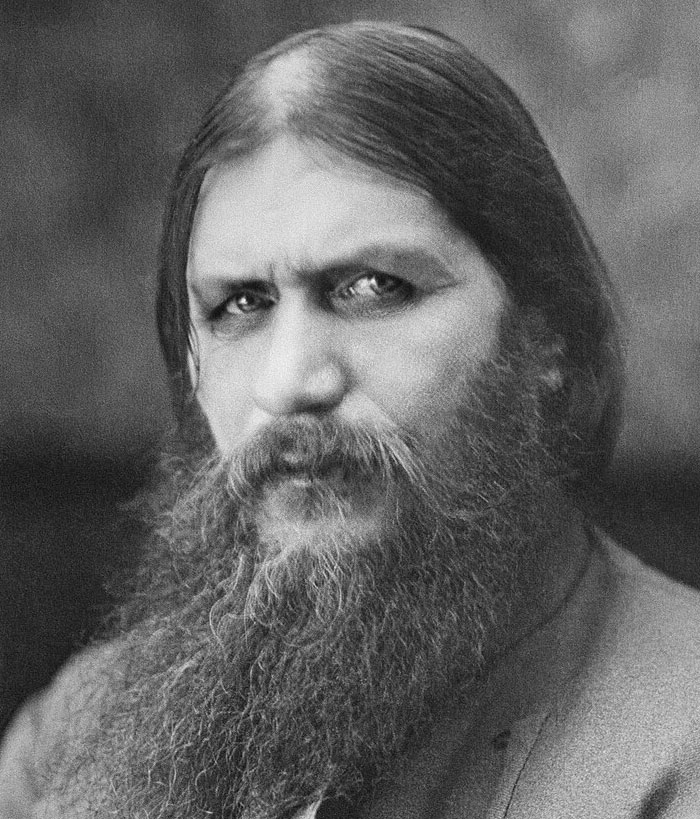 Black and white portrait of a bearded man with intense eyes, representing infamous unsolved mysteries around the world.