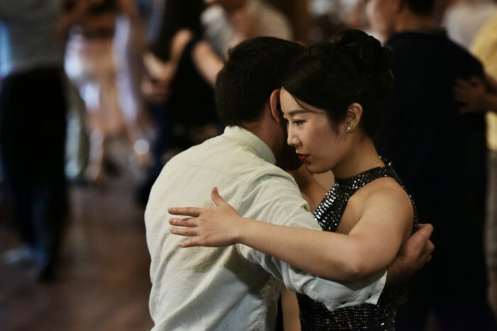 A couple dancing closely at an event, capturing a moment of first date and encounter audacity.