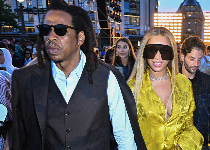 Jay-Z and Beyonc&eacute; wearing sunglasses at an outdoor event, highlighting Blue Ivy's resemblance to her mom.