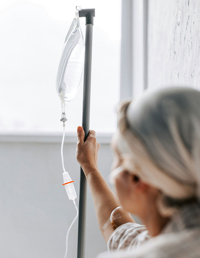 Person holding an IV pole with a drip bag, highlighting weirdly hilarious images that improve mood and social media feed.