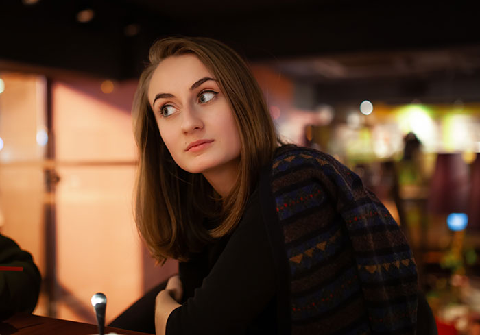 A young woman looking horrified and abandoned on date night, reflecting feelings after boyfriend goes out with friends.