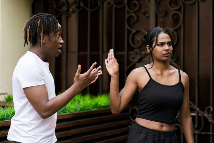 A man with 9 kids pleading with his child-free ex, who reacts with disbelief and laughter outdoors.