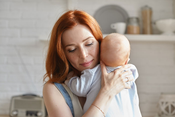 Mother gently holding and comforting her baby, reflecting the emotional bond with a child out of spite theme. Mother gently holding and comforting her baby, reflecting the emotional bond with a child out of spite theme.