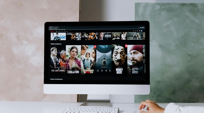 Computer screen displaying Netflix series thumbnails, related to identifying TV shows from their fictional locations.