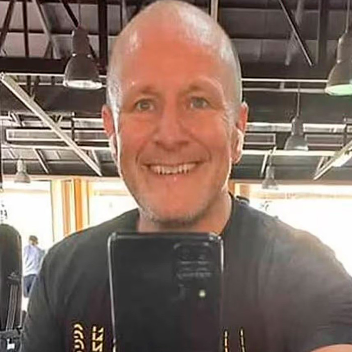 Man taking a selfie in a gym setting, related to legal expert explanation on dad not facing charges.