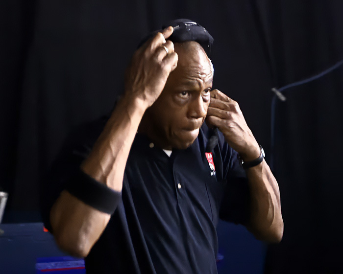 Man wearing black shirt and headset adjusting equipment backstage, relating to Beyoncé’s treatment of 20-year employee debate.