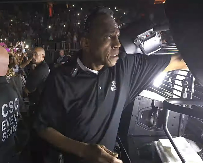 Security staff member working backstage at a concert, highlighting Beyoncé's treatment of a 20-year employee.