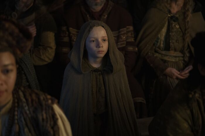Young boy cloaked in medieval attire, portraying Egg, a key character in the Knight Of The Seven Kingdoms prophecy scene. - 3