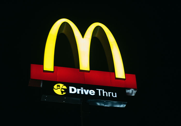 McDonald's drive-thru sign glowing at night, illustrating a scene where criminals were shockingly bad at what they do.