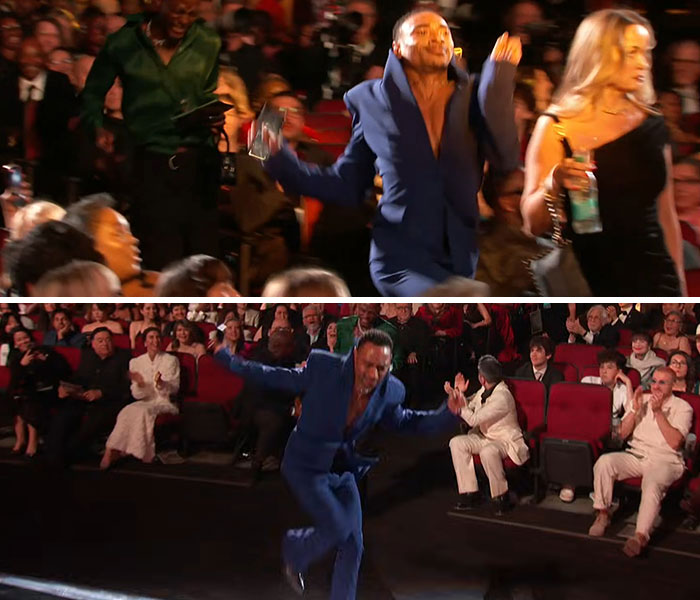 Celebrity in a blue suit making awkward dance moves during the 2026 Grammy Awards with an applauding audience around.