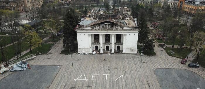 Ruined building with a damaged roof surrounded by debris, evoking a dystopian nightmare atmosphere.