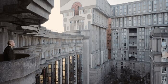 Man standing on a balcony overlooking a massive, brutalist concrete building with a dystopian nightmare atmosphere.