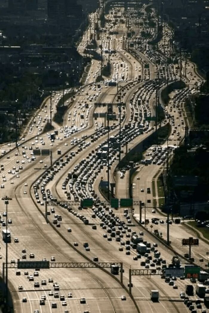 Heavy traffic congestion on a sprawling highway during rush hour, resembling a dystopian nightmare scene.