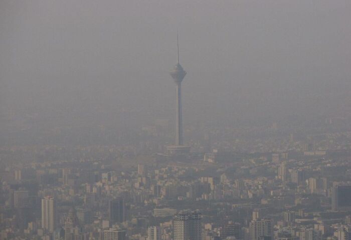 City skyline shrouded in heavy smog, creating a dystopian nightmare atmosphere with limited visibility.