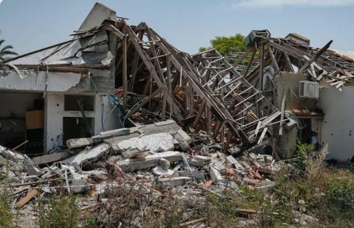 Collapsed building ruins with debris and broken wooden beams, resembling a dystopian nightmare scene from around the world.