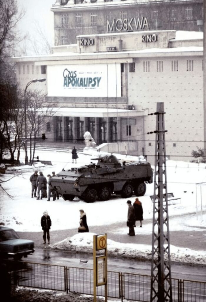 Armored vehicle and soldiers in snowy urban scene, evoking a dystopian nightmare atmosphere in a cold winter setting.