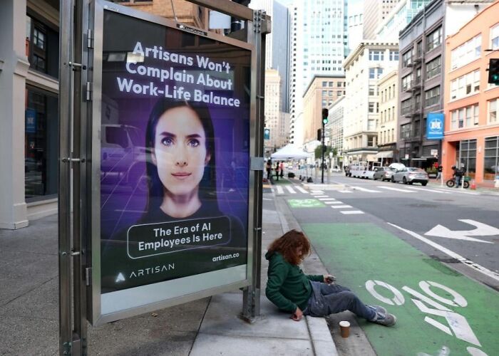Bus stop ad showing a futuristic AI worker with a child sitting on the sidewalk in a dystopian urban setting.