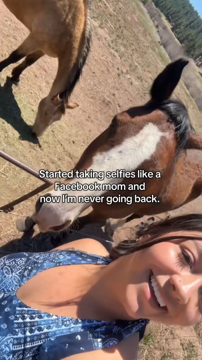 Woman taking hilarious mom selfie outdoors with horses, capturing the chaotic energy of a mom on social media.