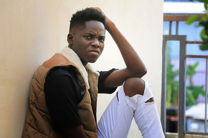 Young man sitting outdoors looking frustrated, representing nephew affected by aunt rearranging schedule for respect issues. Young man sitting outdoors looking frustrated, representing nephew affected by aunt rearranging schedule for respect issues.