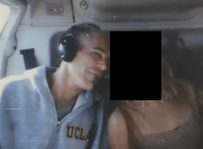 Man wearing UCLA sweatshirt with headphones inside vehicle, related to sulfuric acid purchase for Epstein Island FBI probe.
