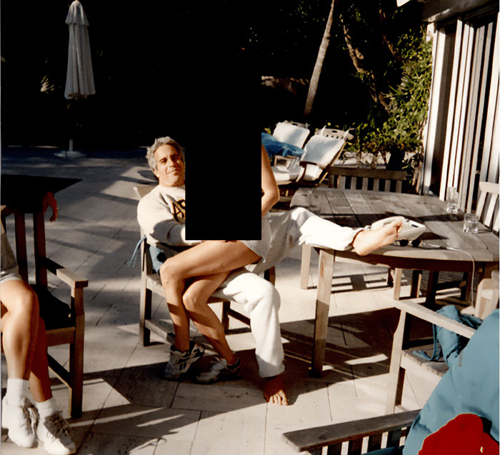 Man sitting outdoors on wooden chair at table with 330 gallons of sulfuric acid linked to Epstein Island FBI probe