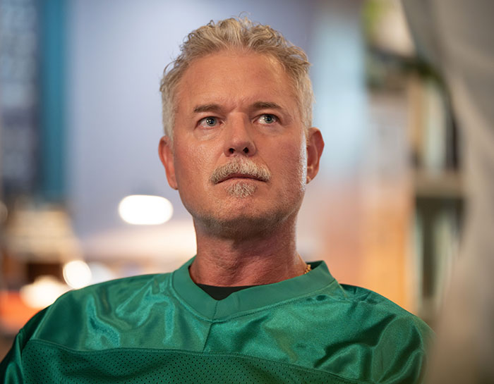 Man wearing a green shirt looking thoughtful, representing Eric Dane’s stunning first symptom leading to ALS diagnosis.