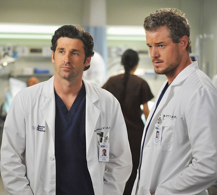 Two doctors in white coats in a hospital setting, representing Eric Dane’s first symptom leading to ALS diagnosis.