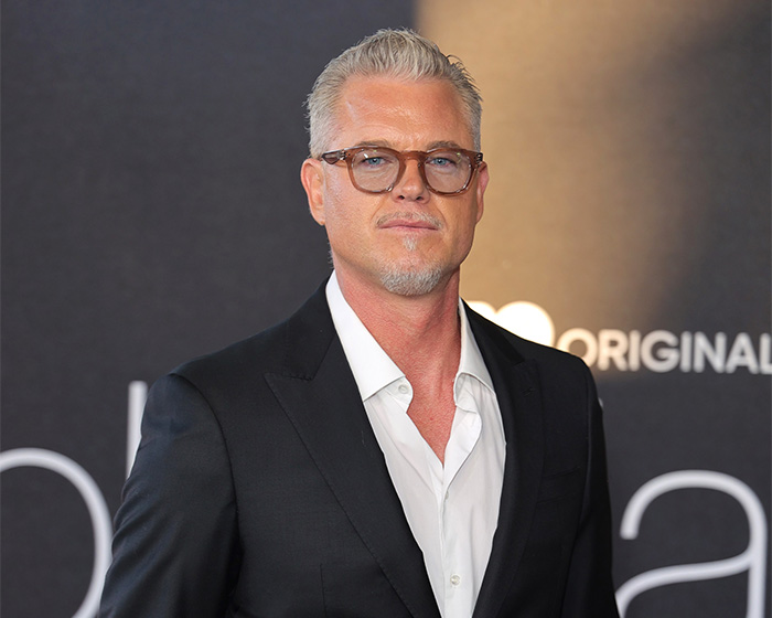 Eric Dane wearing glasses and a black suit, attending an event related to his heartbreaking last words for his daughters.