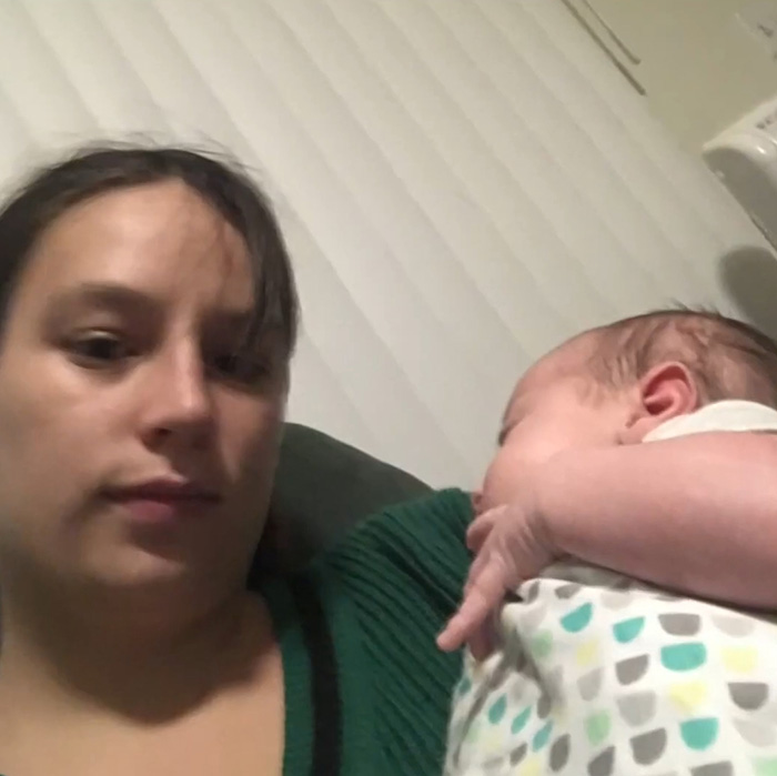 Young mother holding baby girl wrapped in patterned blanket, highlighting horrifying exchange between young parents after tragedy.