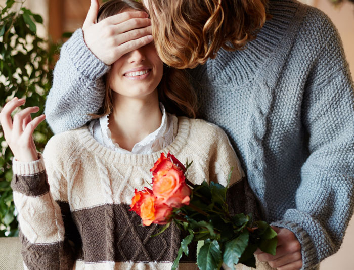 Woman surprised by high school bestie with roses, showcasing love and cheeky surprises after marriage for tax perks