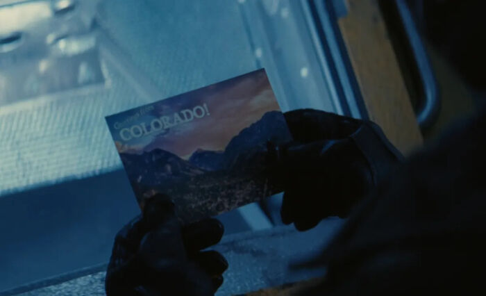 Hands holding a postcard of Colorado landscape, related to Fallout Season 3's new setting in Colorado. - 2