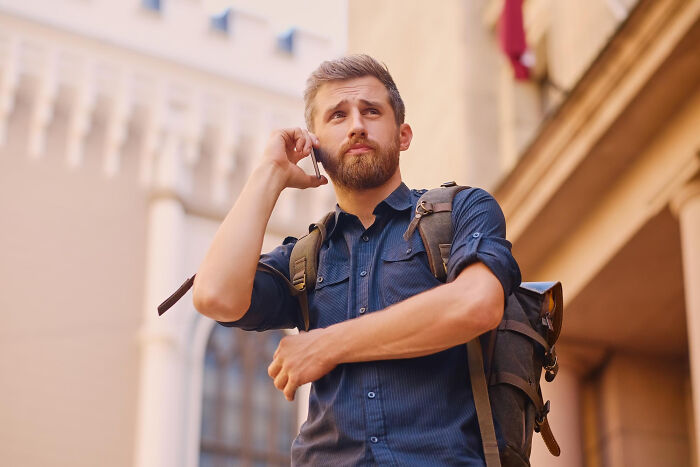 Young man with a backpack showing emotional reflection, depicting the reality of being related to an ICE agent.