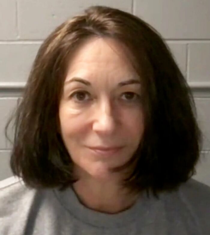 Woman with shoulder-length brown hair in a neutral expression, representing emotional realities of being related to an ICE agent