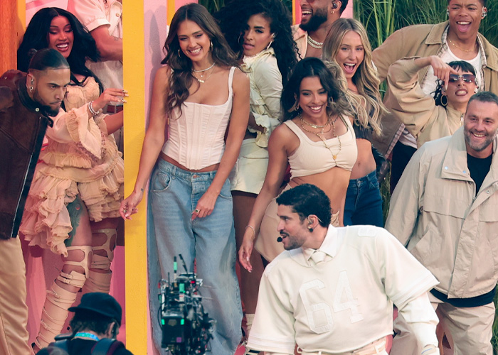 Jessica Alba dancing at Super Bowl halftime show with a group of performers amid fan reactions and lively stage atmosphere.