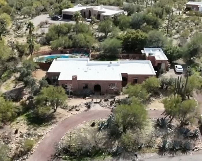 Aerial view of a desert home surrounded by cacti and trees, related to FBI revealing chilling ransom note details.