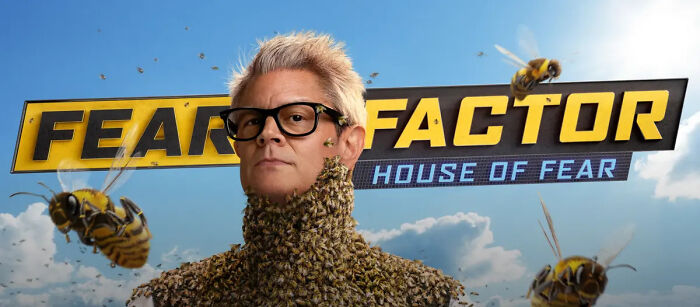 Host from Fear Factor House of Fear episode, wearing glasses and bee-covered outfit with bees flying around.