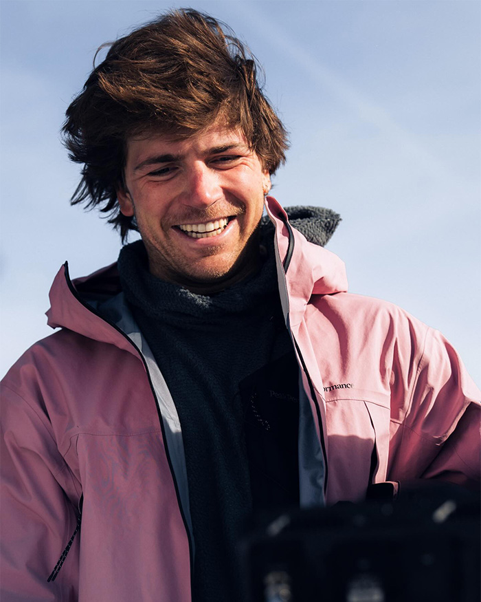 Smiling man in outdoor jacket, with fans accusing Olympics figure skating judges of suspicious scoring against Team USA.