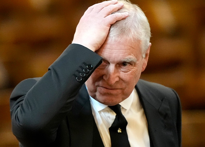 Prince Andrew with a distressed expression, touching his head, showing a terrified look after his arrest.
