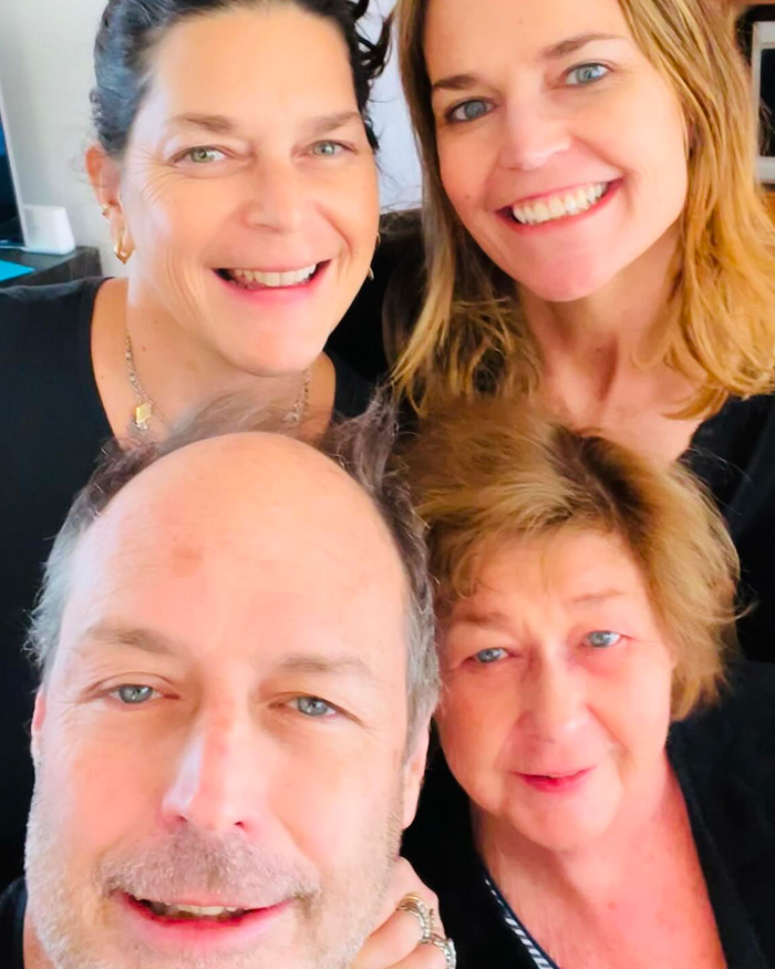 Group selfie of four people smiling warmly, related to first sketch of Nancy Guthrie's masked suspect by forensic artist.