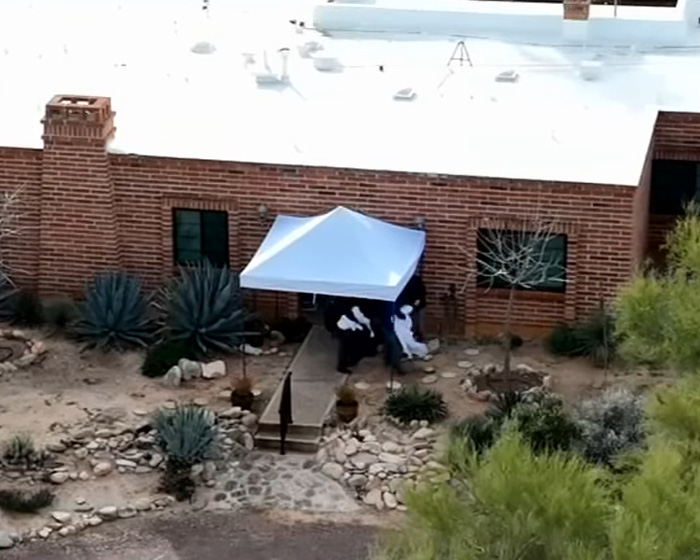 Forensics team setting up white tent at Nancy Guthrie's home amid investigation days after kidnapping incident.