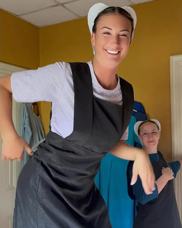 Smiling woman dressed in Amish clothing inside a Pennsylvania home joining Amish community after leaving LA.