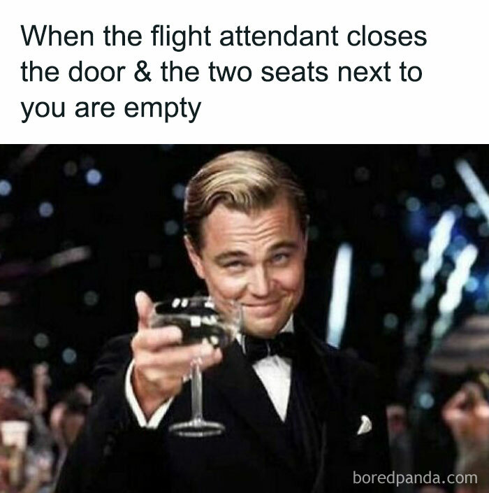 Man in tuxedo raising a glass in celebration, illustrating travel meme about empty seats on a flight.