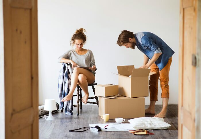 A young man and woman with moving boxes, illustrating stories of how friendships ended without even starting.